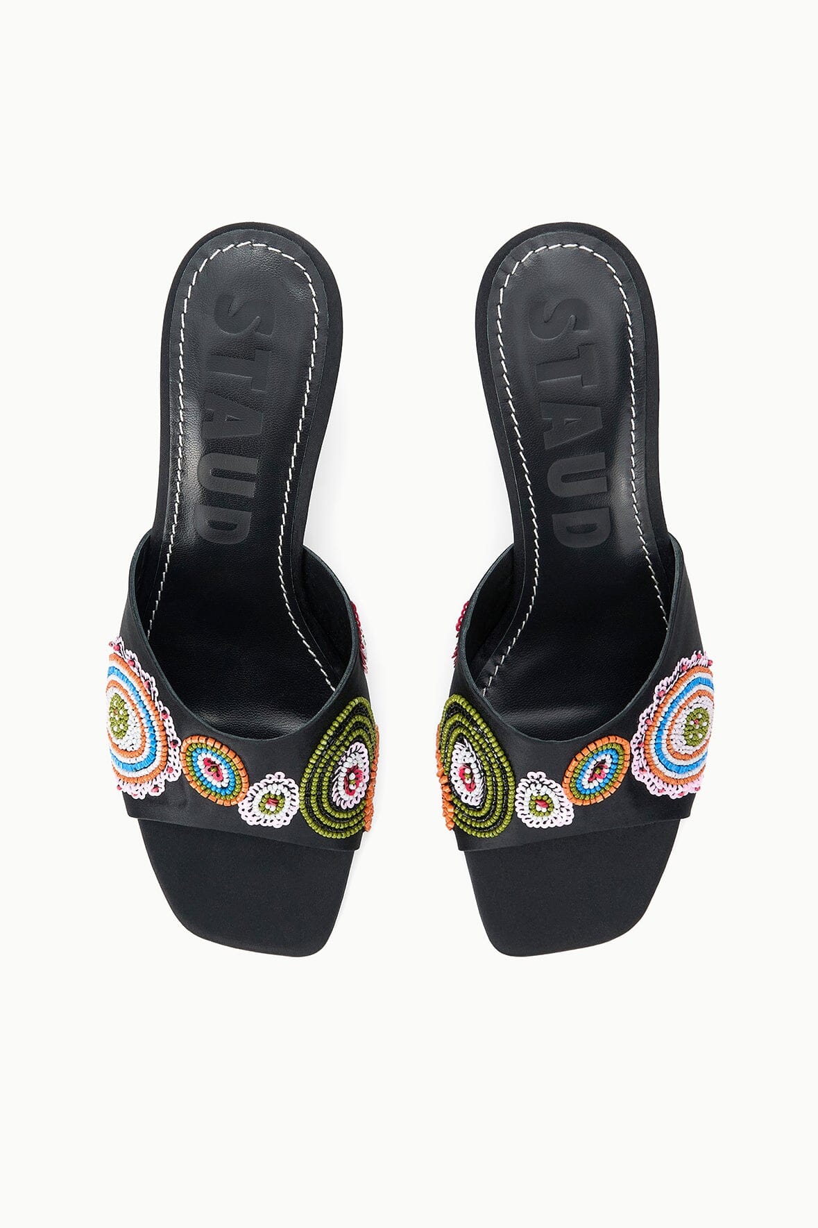 Pair of black mules with colorful bead-embroidered straps, open back, heel view