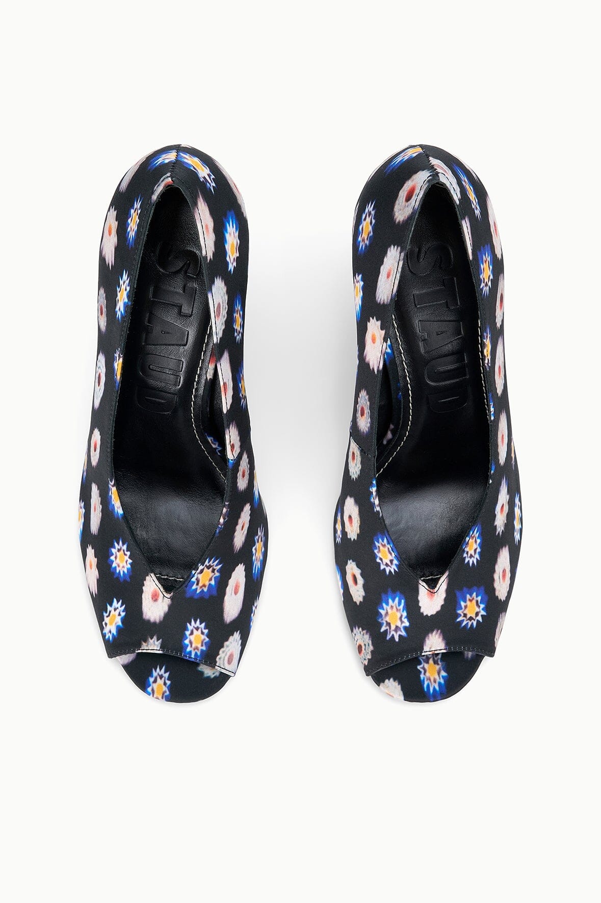 Two peep-toe wedge heels with dark floral print uppers, top view