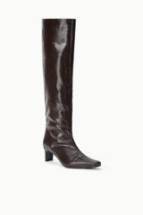 Front view of dark espresso brown knee-high snake-embossed boot with low block heel.