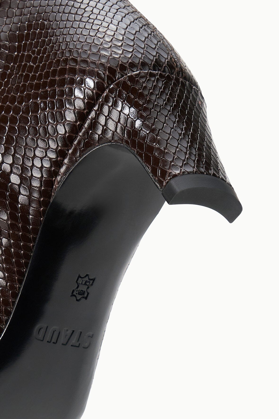 Close-up of dark espresso brown snake-embossed boot upper and heel sole detail.