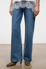 Cheetah-print ankle boots with low heel, side view with blue jeans