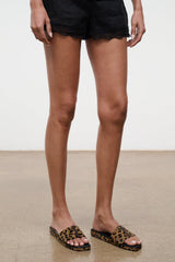 Cheetah-print platform slide sandals on model feet