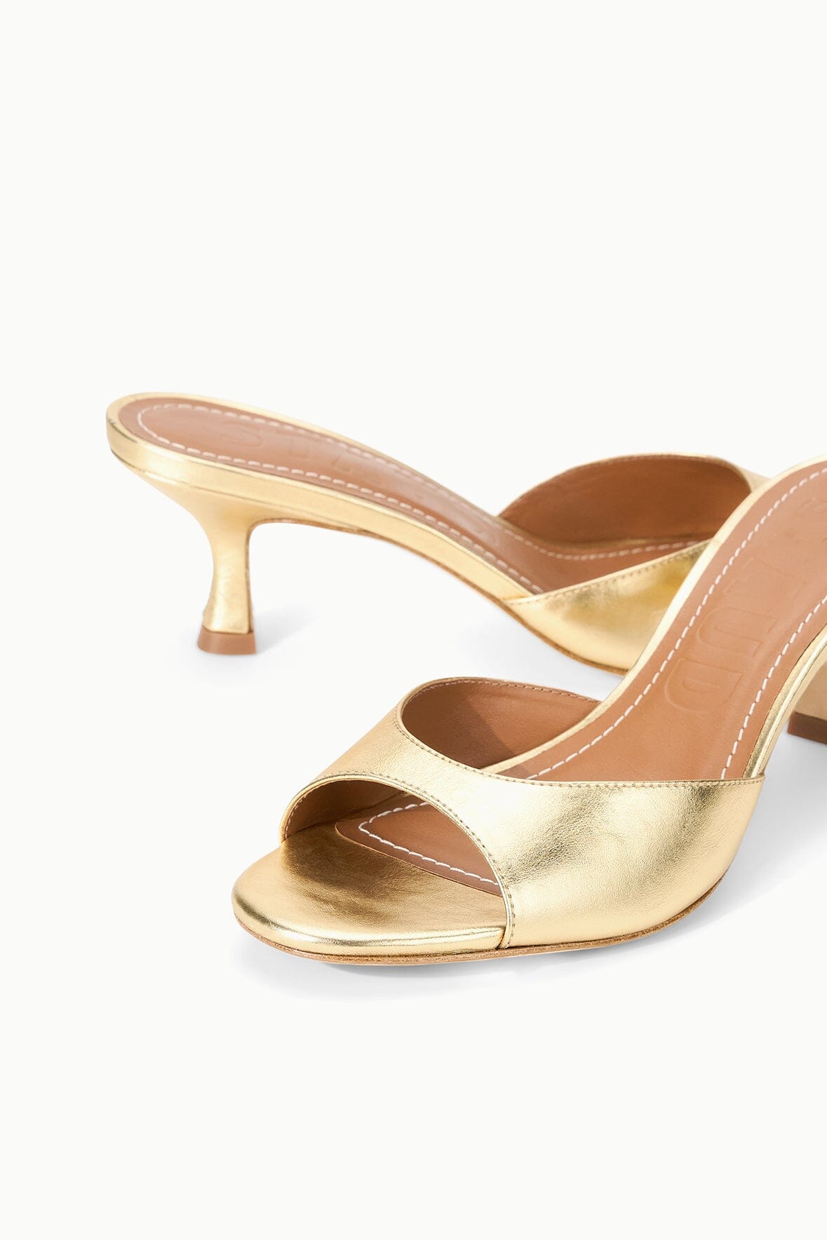 Gold leather mule sandal with cross strap upper and medium heel