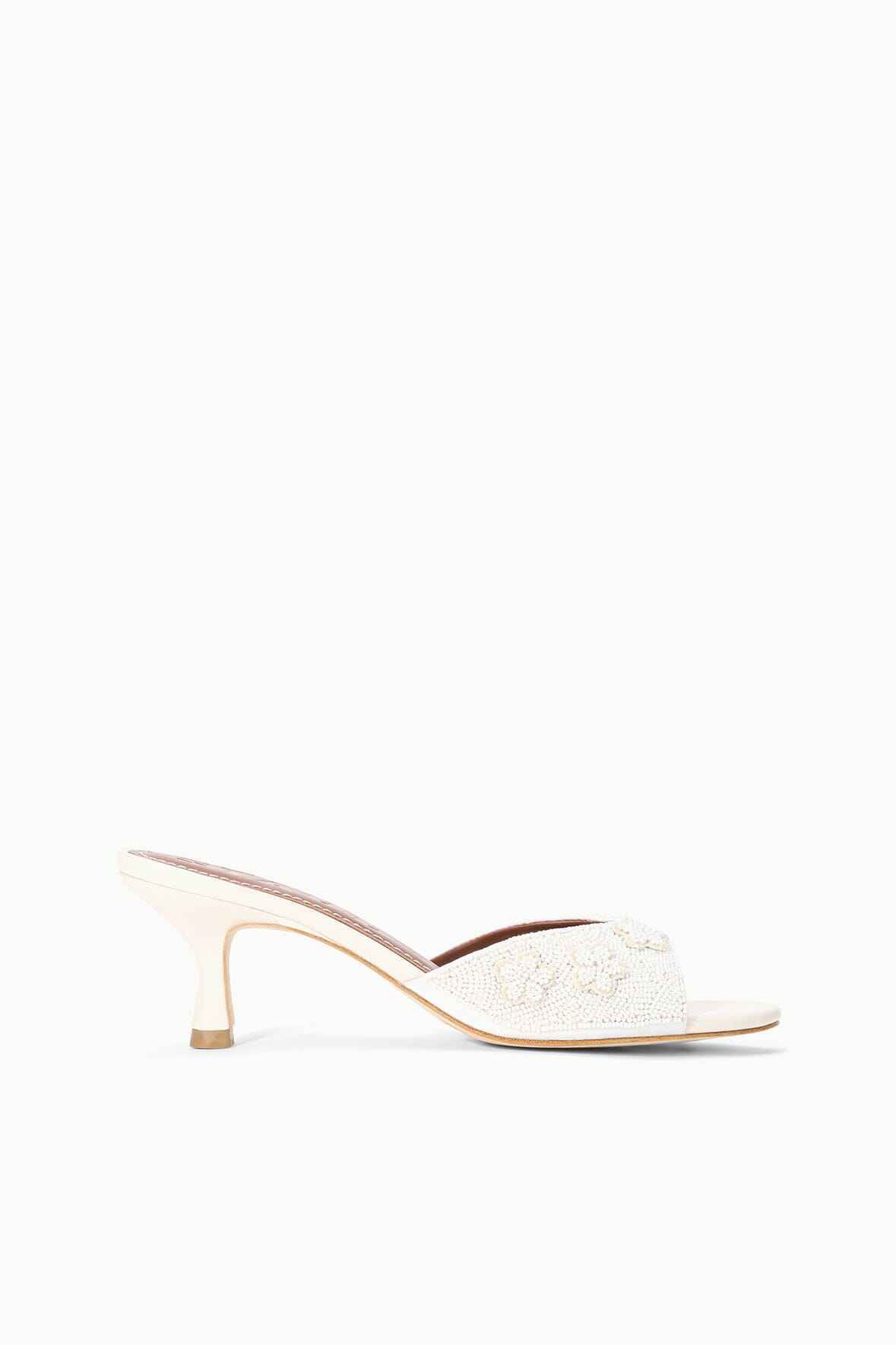 White textured open-back mule sandal with mid-height heel, side view