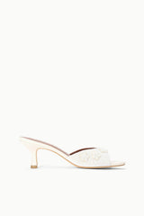White textured open-back mule sandal with mid-height heel, side view
