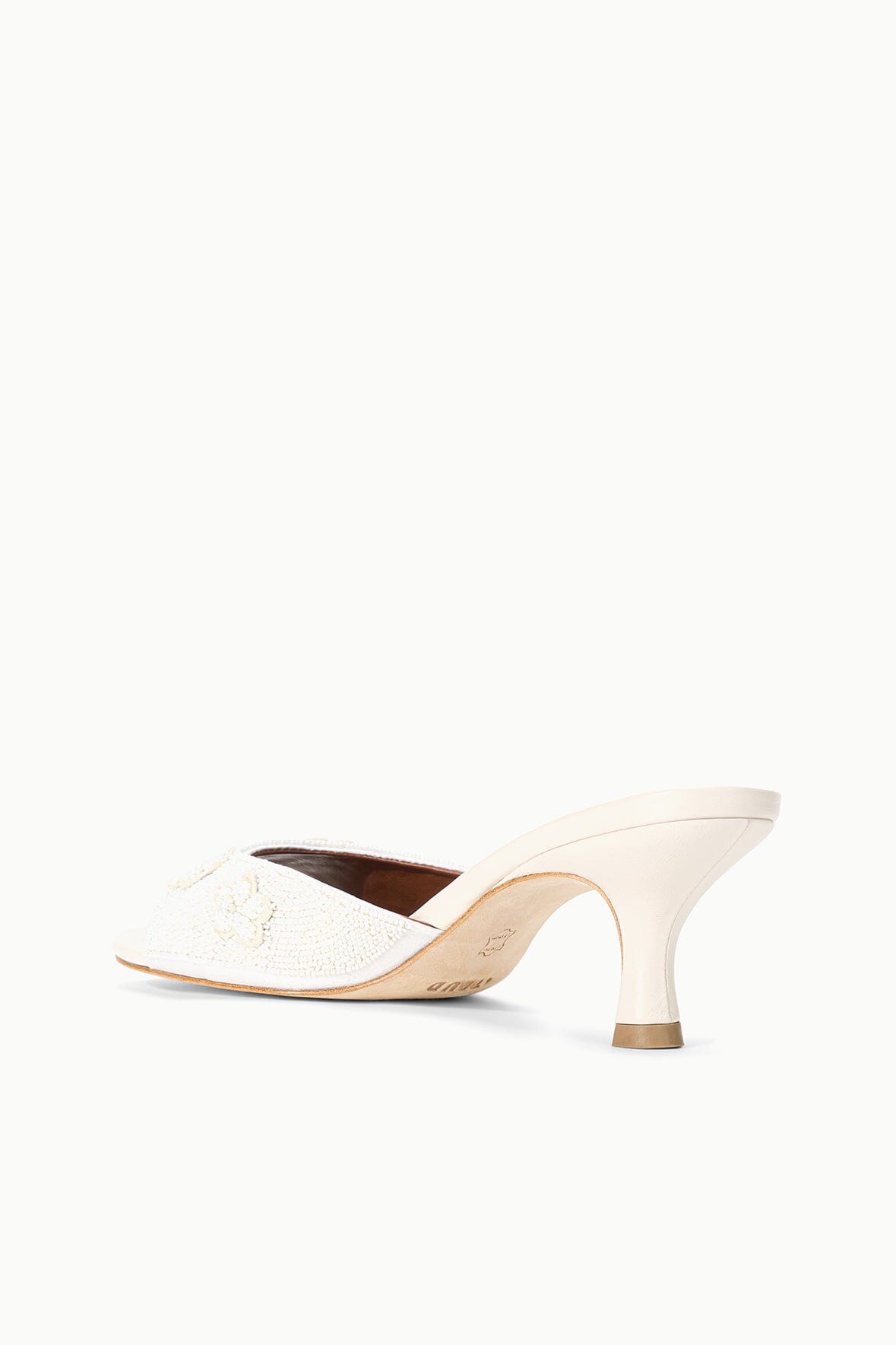 White open-toe mule sandal with textured upper and curved mid-height heel