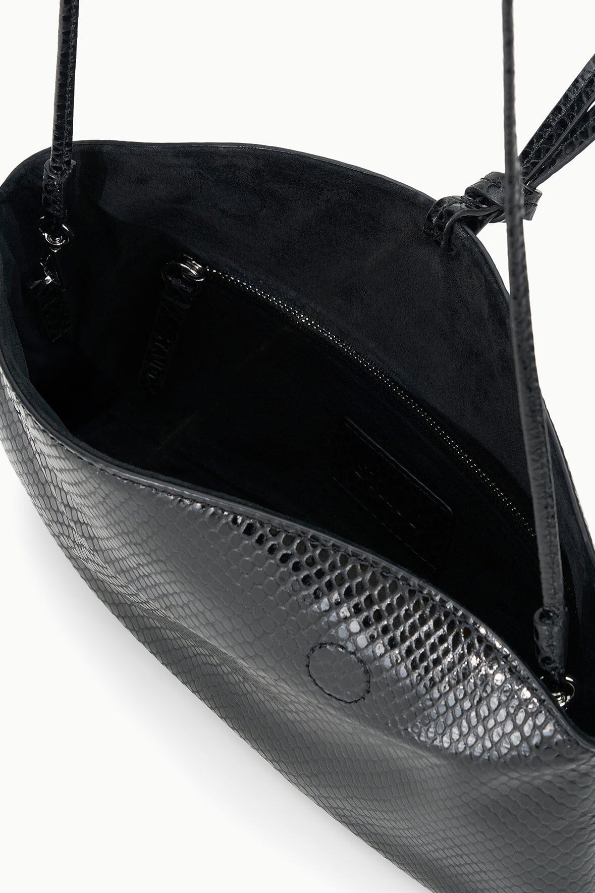 Black snake-embossed clutch interior with zip pocket and fabric lining