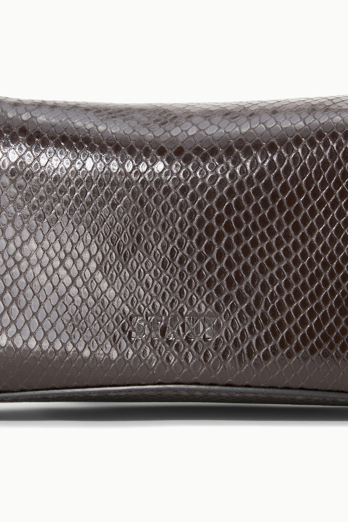 EVE clutch close-up: dark brown embossed snake pattern with smooth trim edge