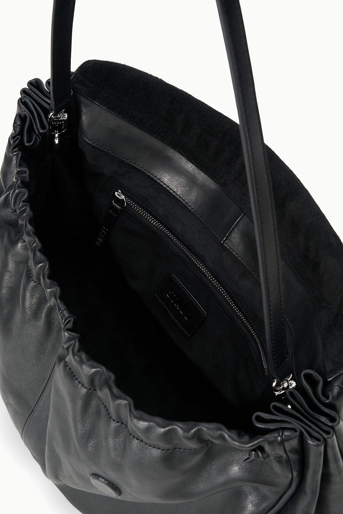 Black oversized bag interior with zip pocket and stitched lining