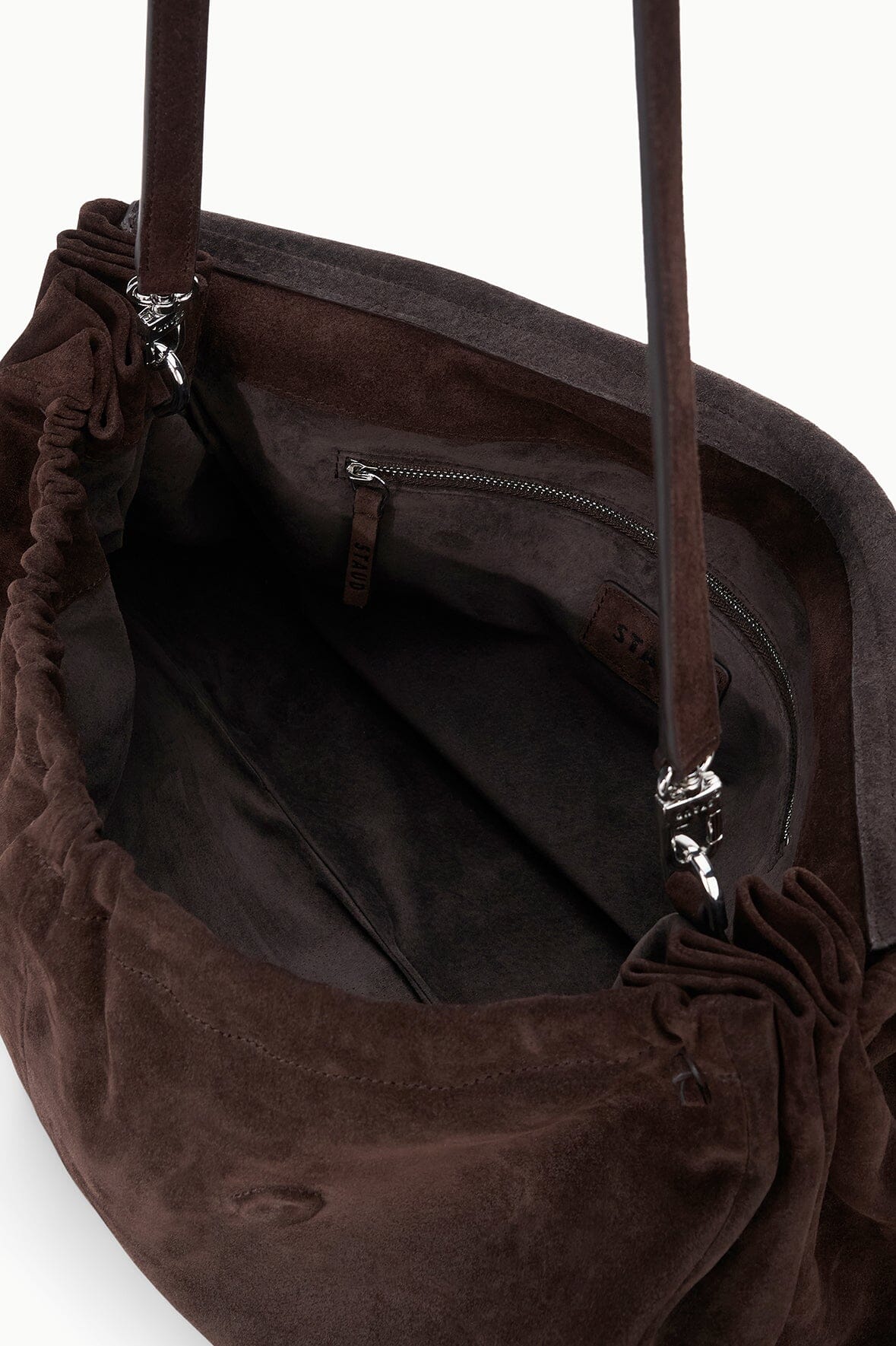 Oversized brown suede bag interior with drawstring top and zip pocket