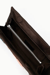 Black clutch bag open, showing black interior and silver zipper detail
