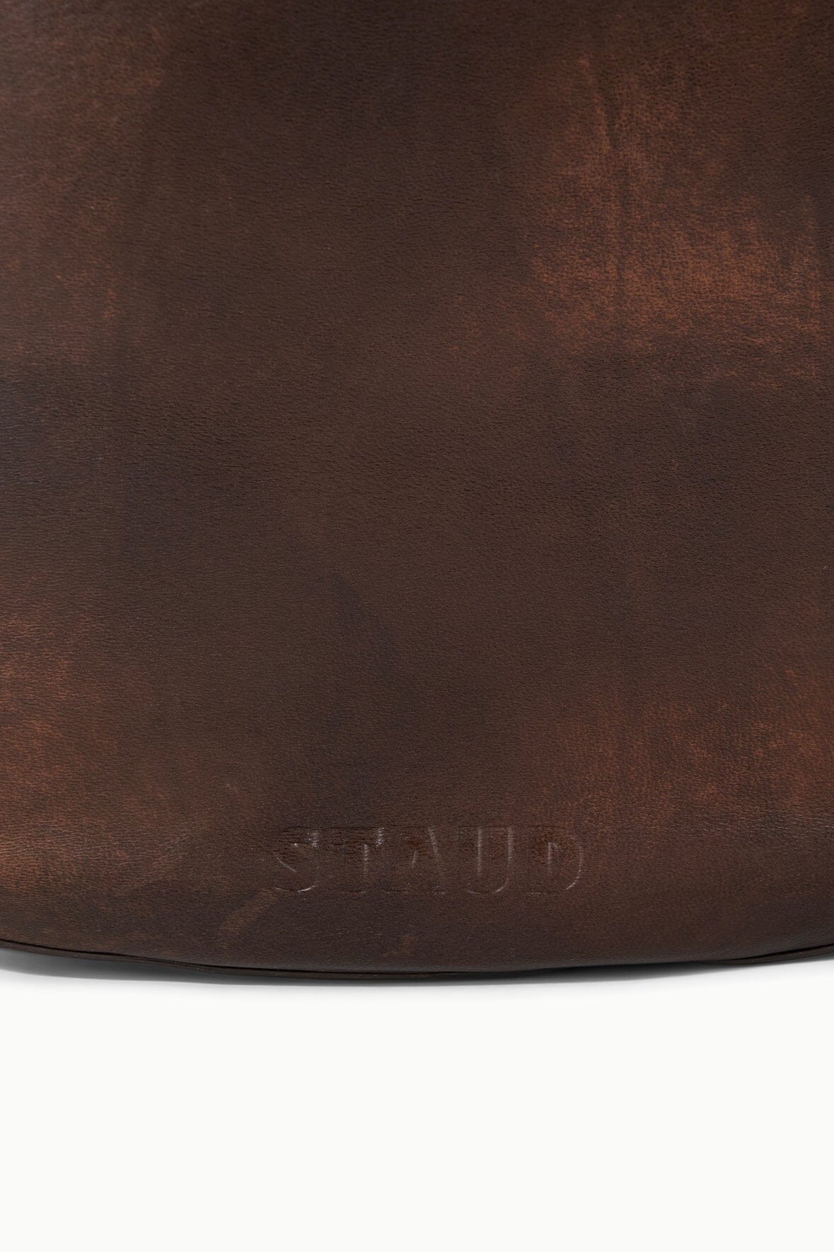 Distressed espresso brown leather hobo bag close-up of bottom edge texture