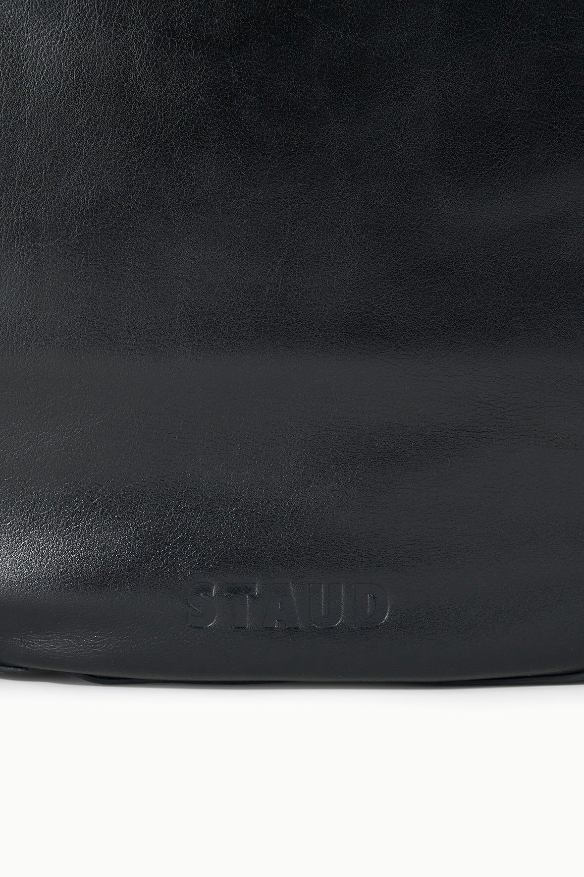 Black hobo bag with embossed STAUD logo near bottom front