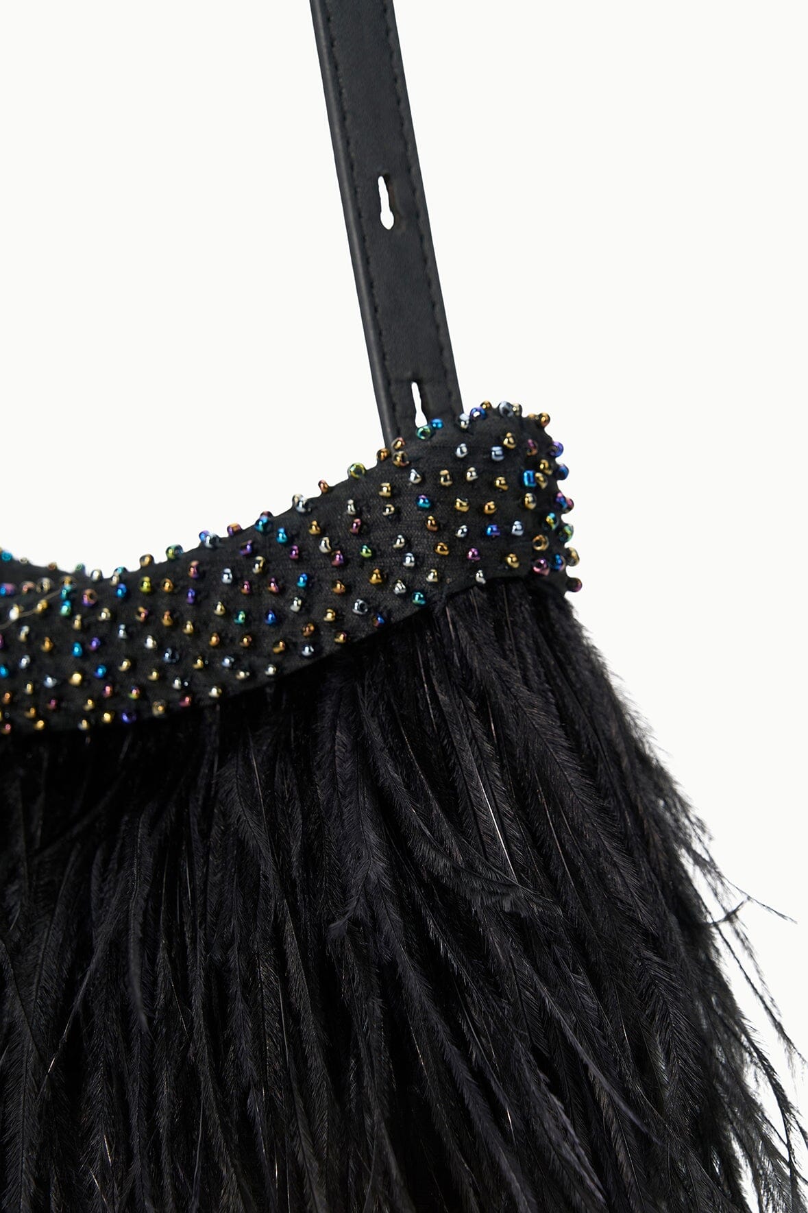 Close-up of black feather fringe with colorful jeweled bead trim