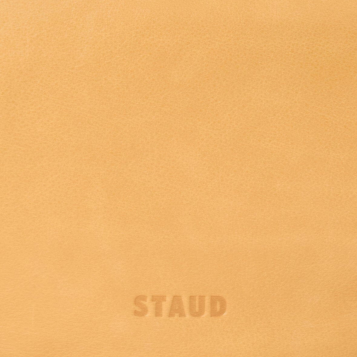 Levi cashew bag close-up of bottom logo stamp: STAUD