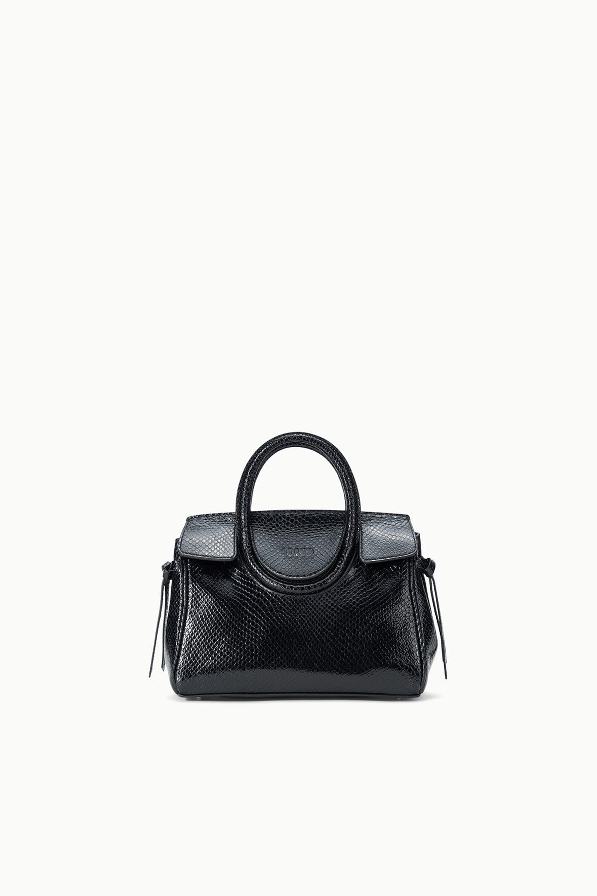 Maude mini carryall bag with structured body, curved handle, and dangling tassels
