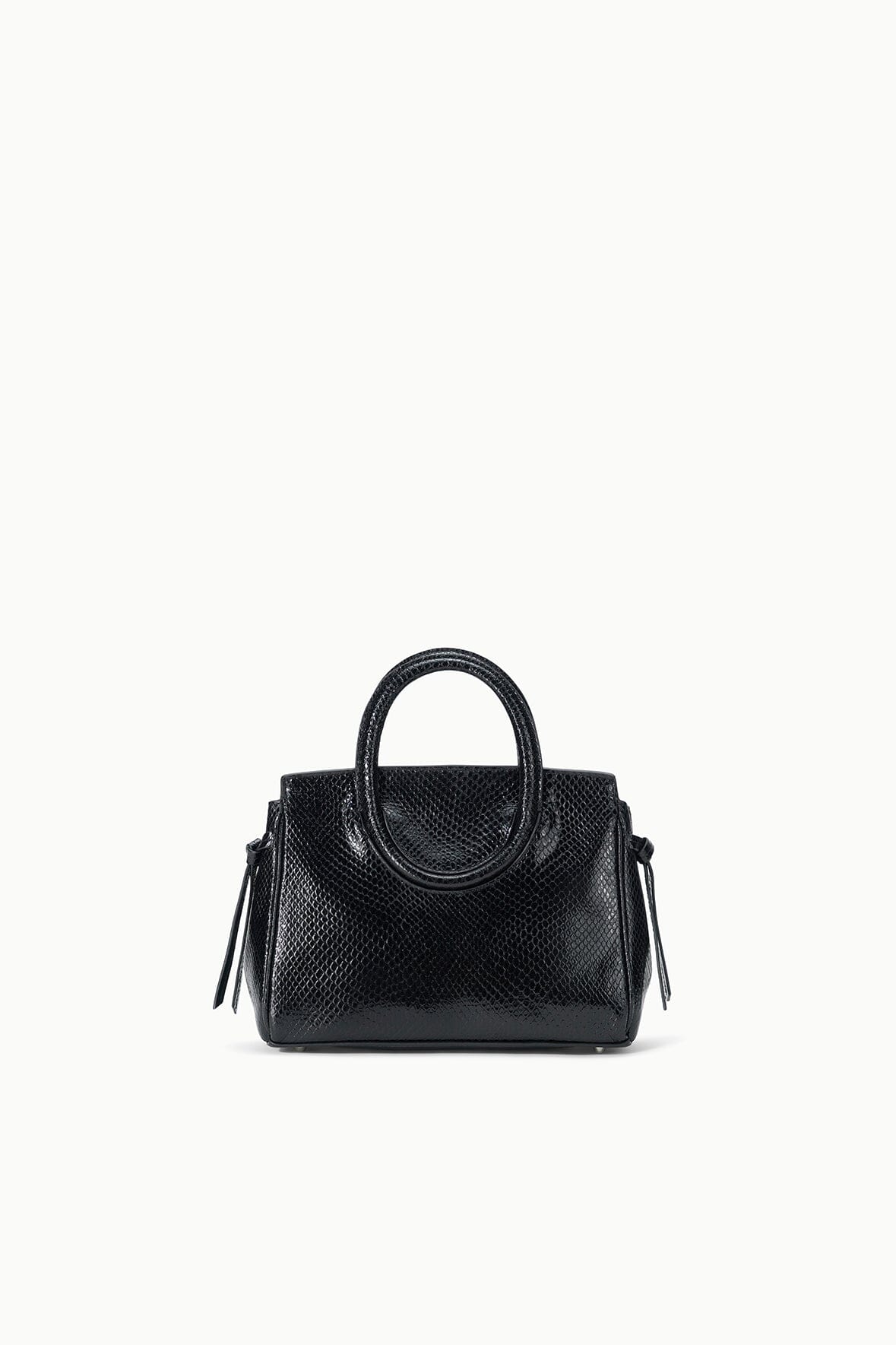 Maude mini carryall bag in black textured leather, top handle and side tassel pulls