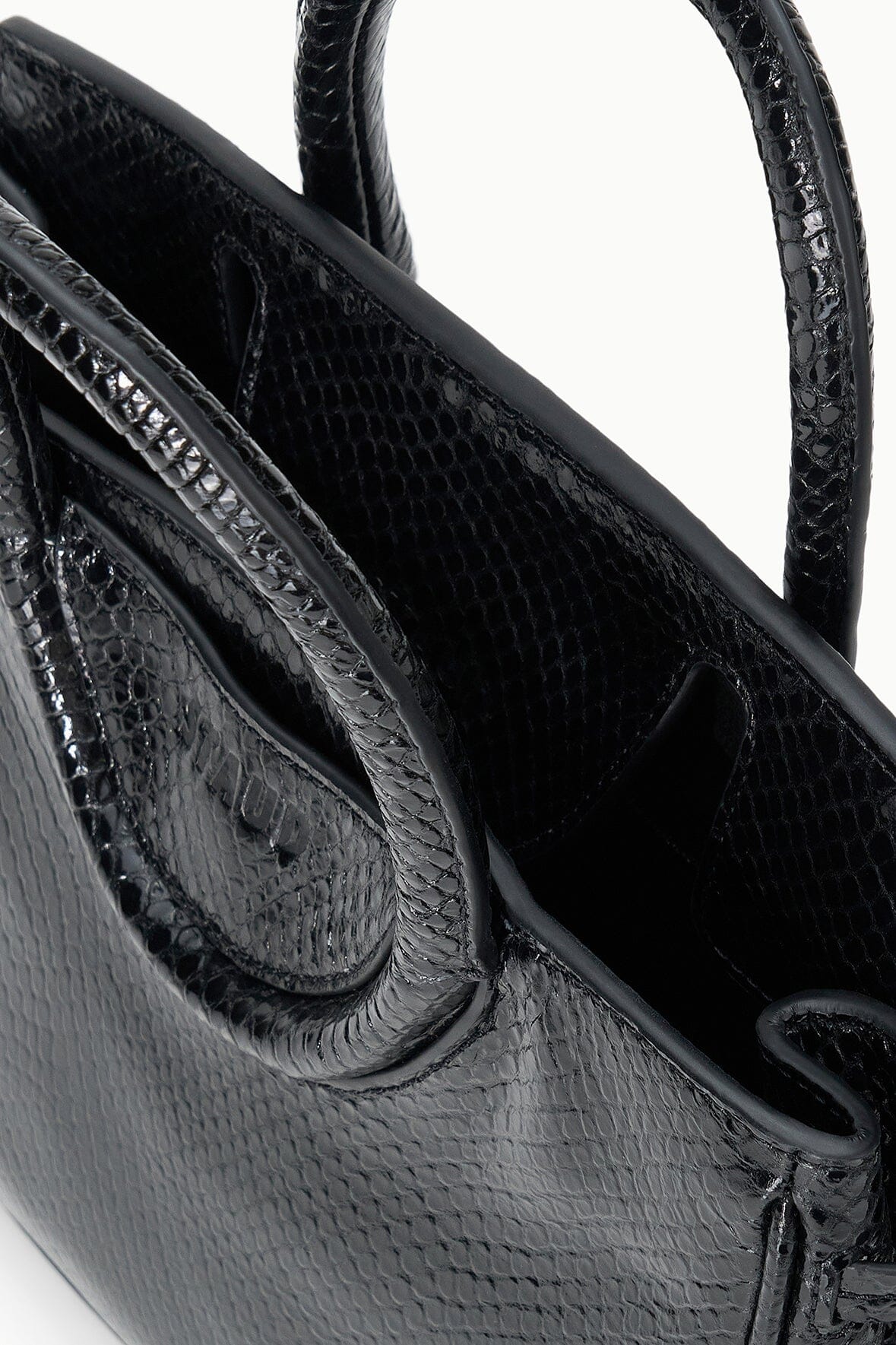 Maude mini carryall bag detail: croc-embossed strap with rounded flap and stitching