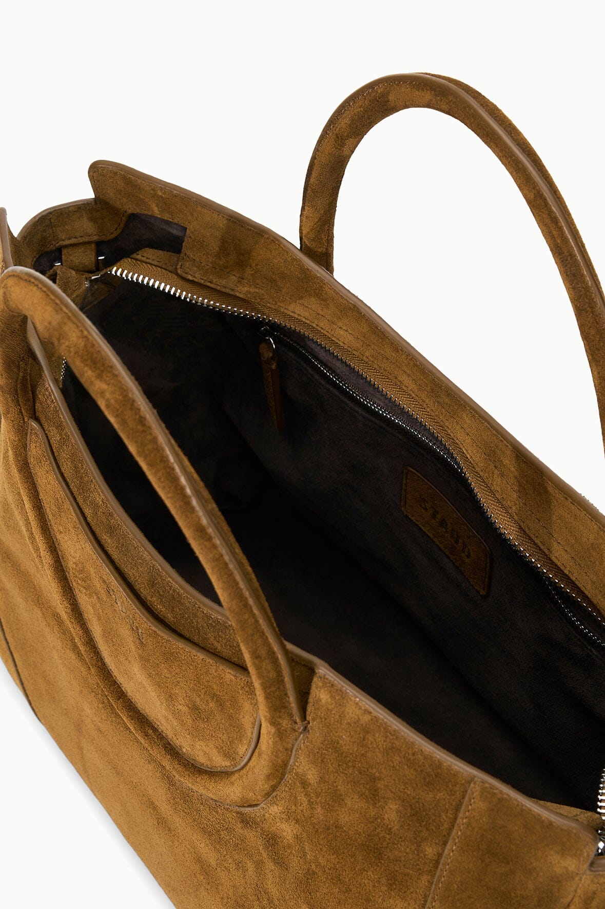 Dark tan suede satchel interior with zipper closure and side slip pocket