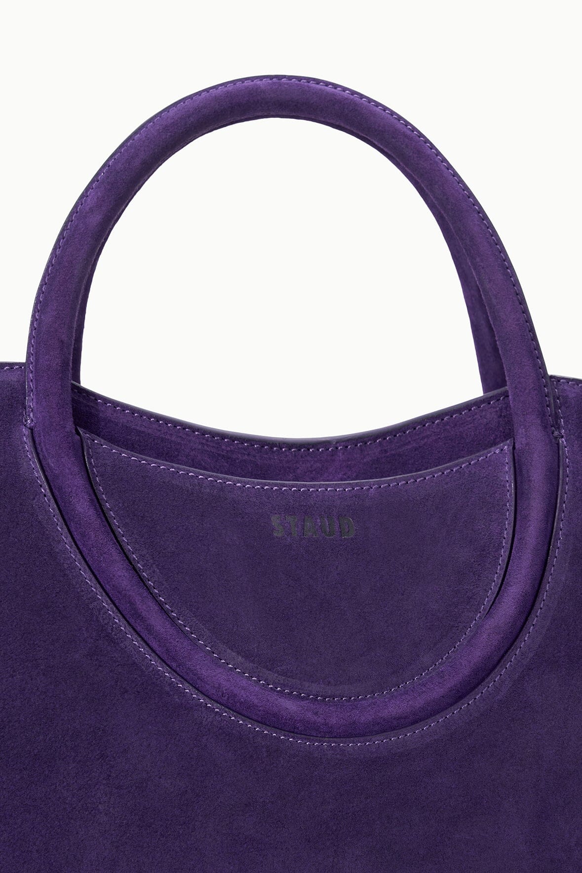 MAUDE SATCHEL amethyst satchel bag close-up of top handle and front logo patch