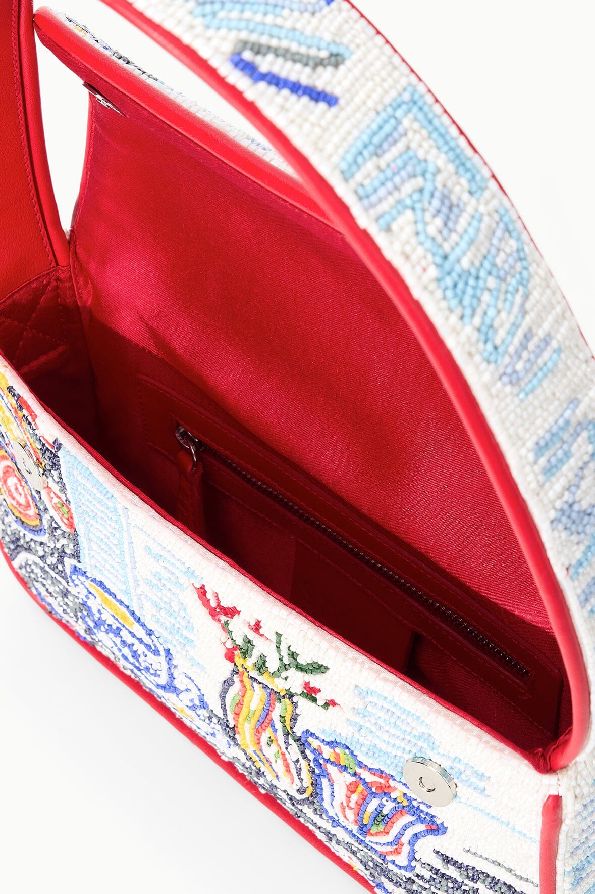 Beaded bag with red-lined interior and visible zip pocket, open flap view