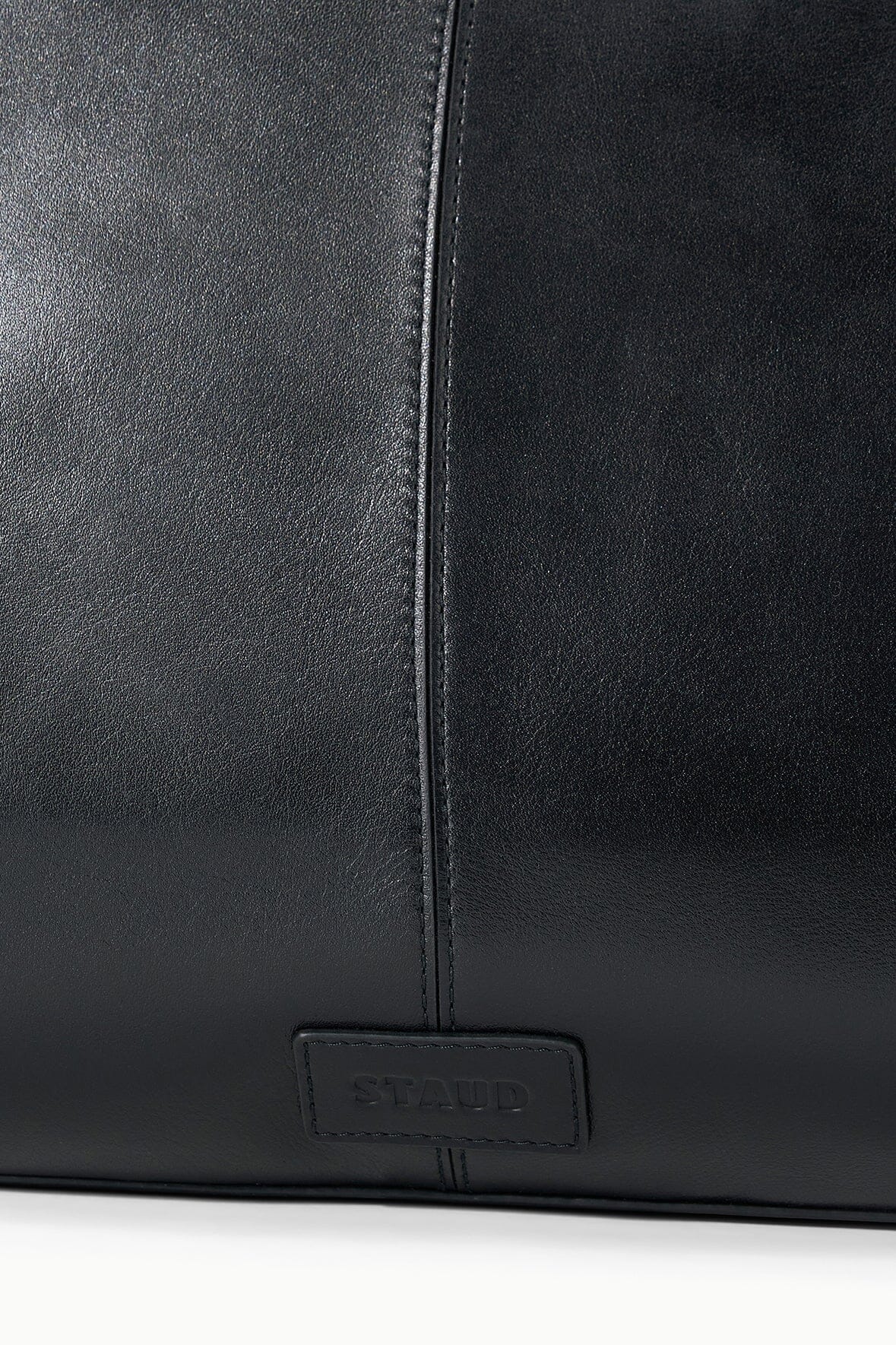 Black satchel bag with stitched seam and HESTER logo plaque