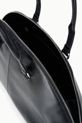 Black satchel bag interior with zip pocket, zipper track, and metal pull