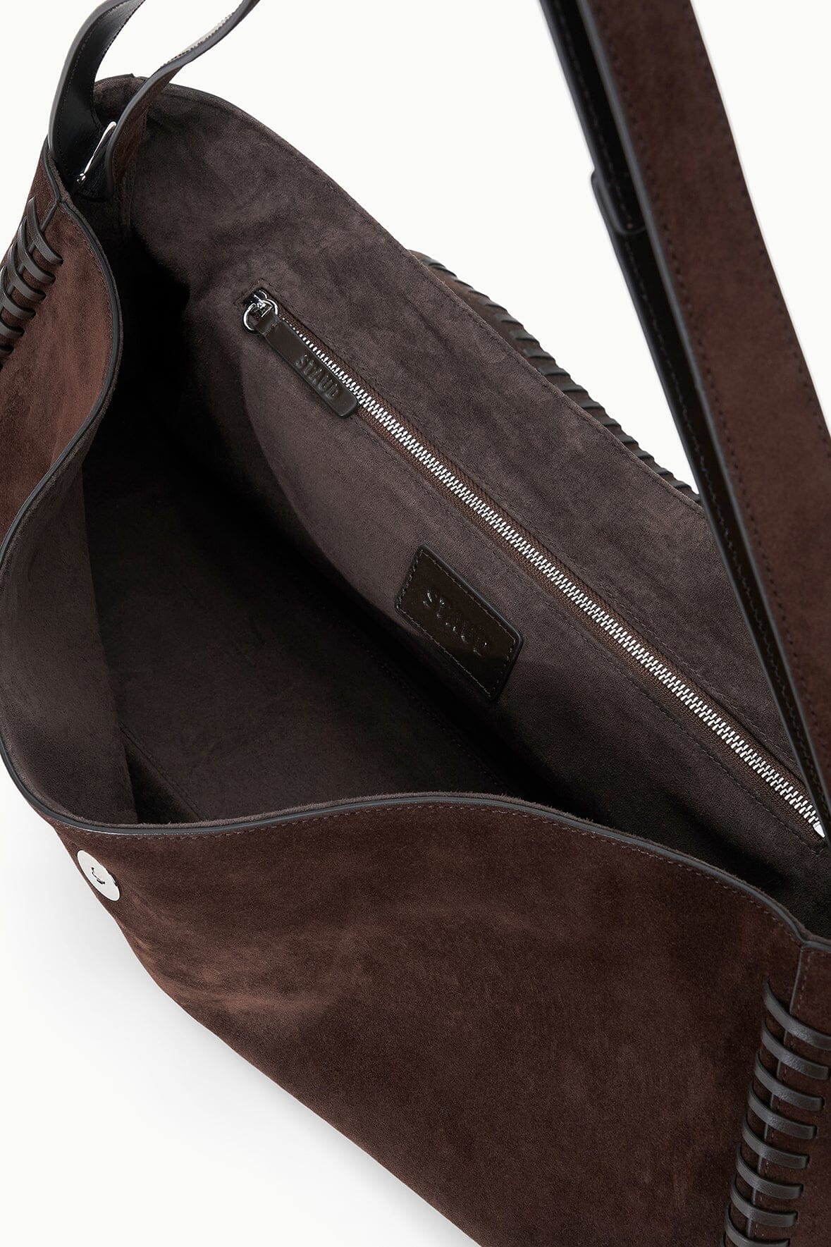 Espresso brown suede messenger bag interior with zip pocket and leather trim.