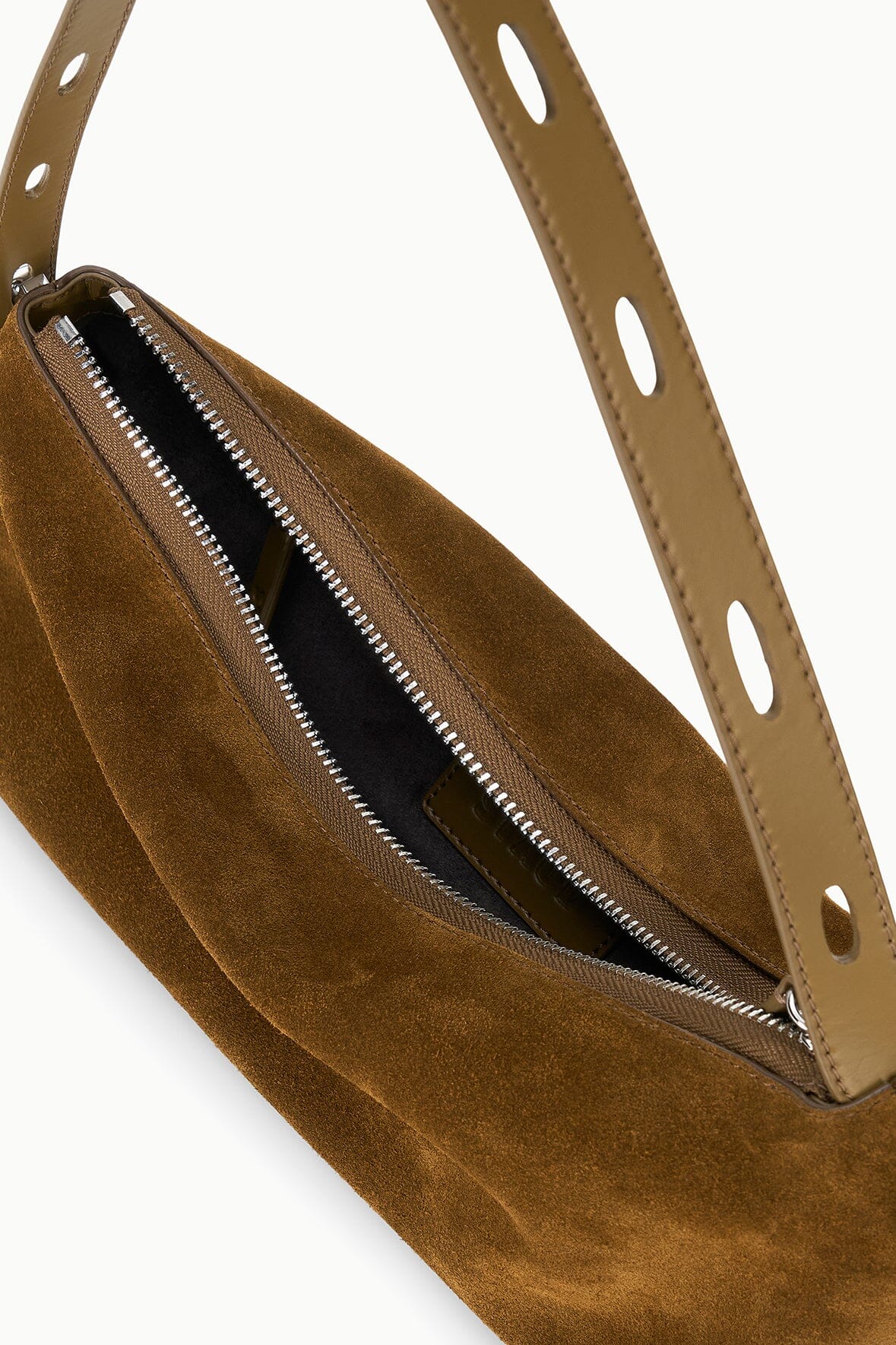 Brown suede shoulder bag interior with zippered compartment and perforated strap
