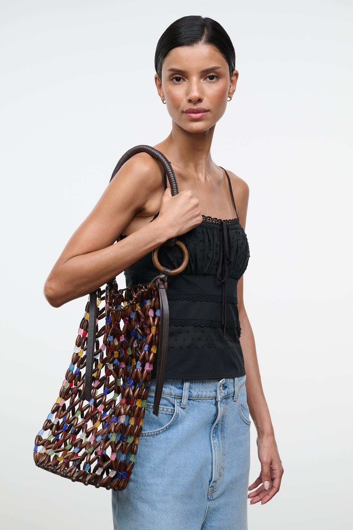 Del Mar bucket bag shown at angle with multicolor beaded lattice and round ring top handle
