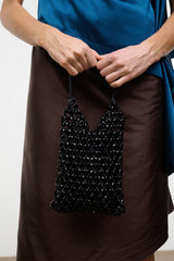 Black beaded mini tote bag on model hands, open weave with knotted handles
