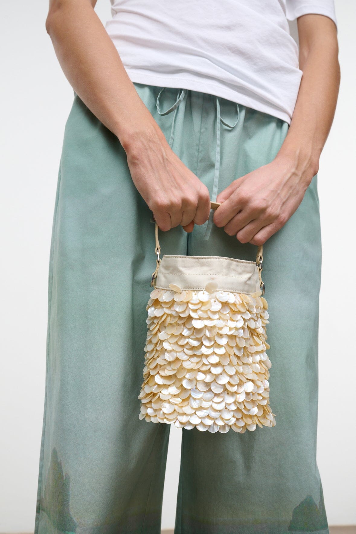 Cream sequin LILA mini bag with flap closure and shoulder strap, front view