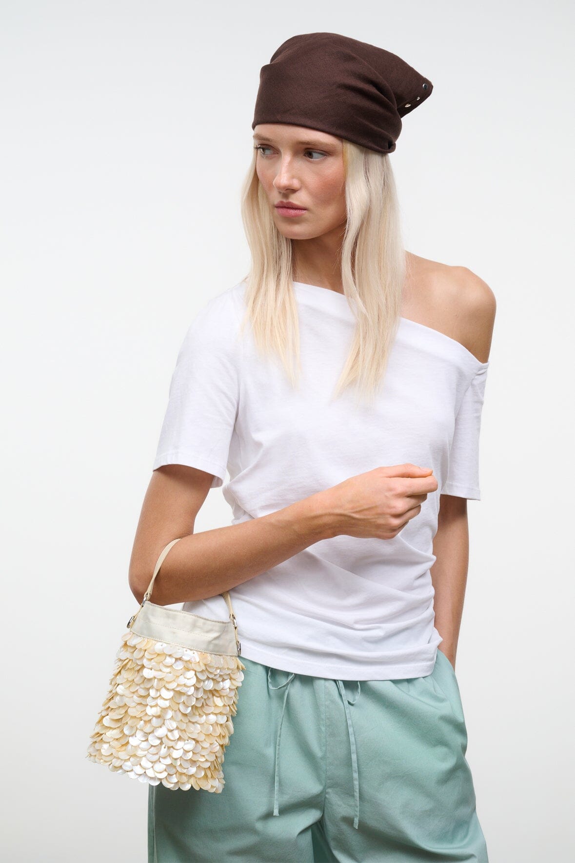Cream sequin LILA mini bag with long shoulder strap and flap closure, side view