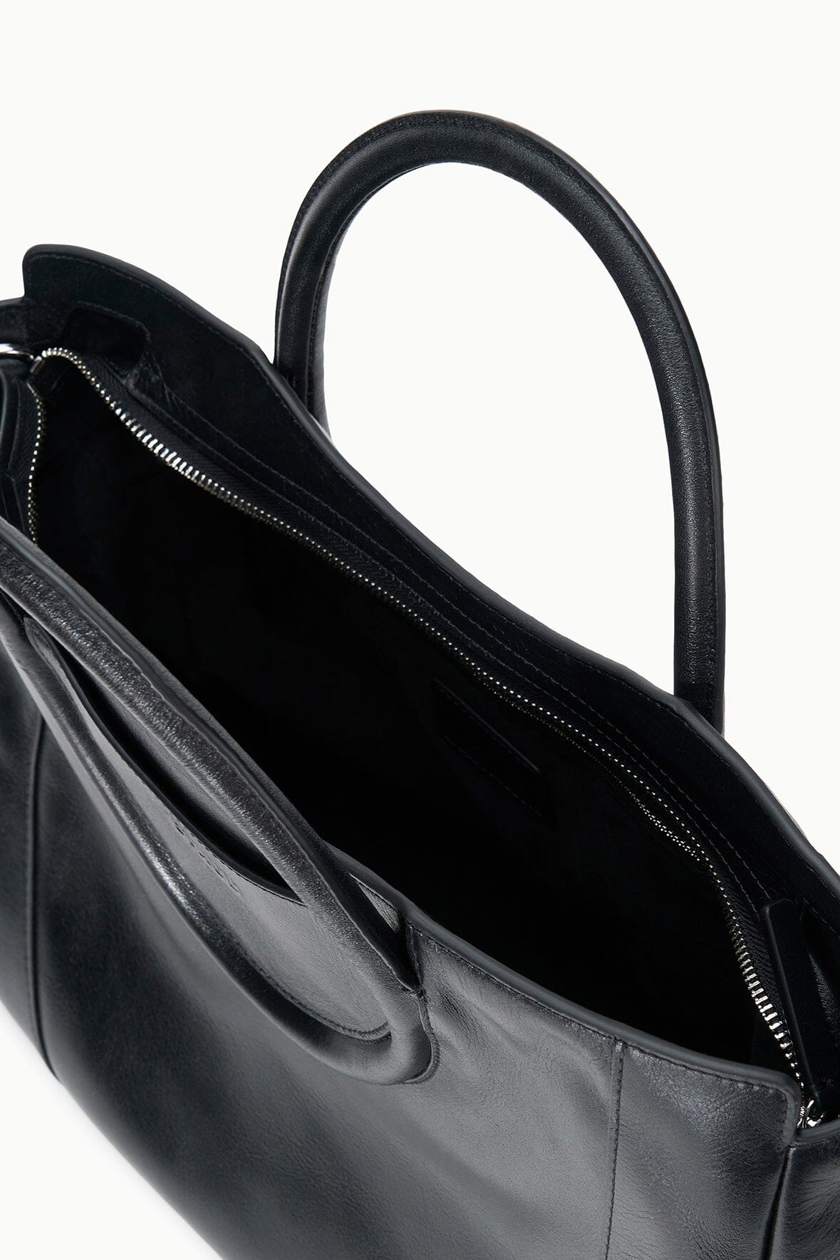Maude black satchel interior view with zip top and lined compartment