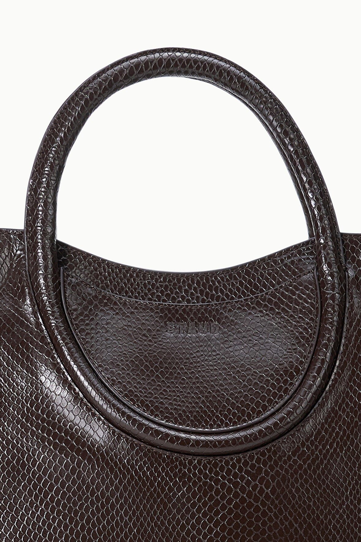 Espresso snake-embossed satchel close-up of curved handle and stitched trim
