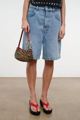 Cheetah-print OLLIE bag held by burgundy strap with gold ring hardware