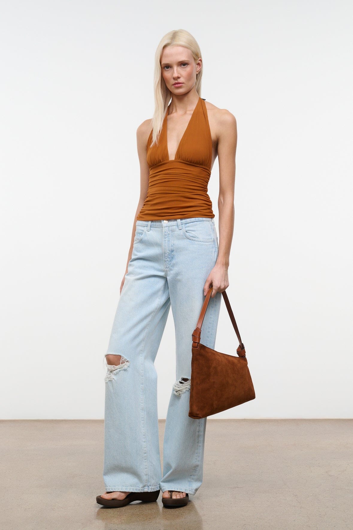 Tabac suede shoulder bag worn by model, slouchy triangular hobo profile