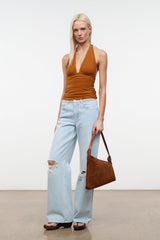 Tabac suede shoulder bag worn by model, slouchy triangular hobo profile