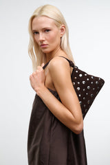 Dark brown mini shoulder bag with silver studs and short top handles.