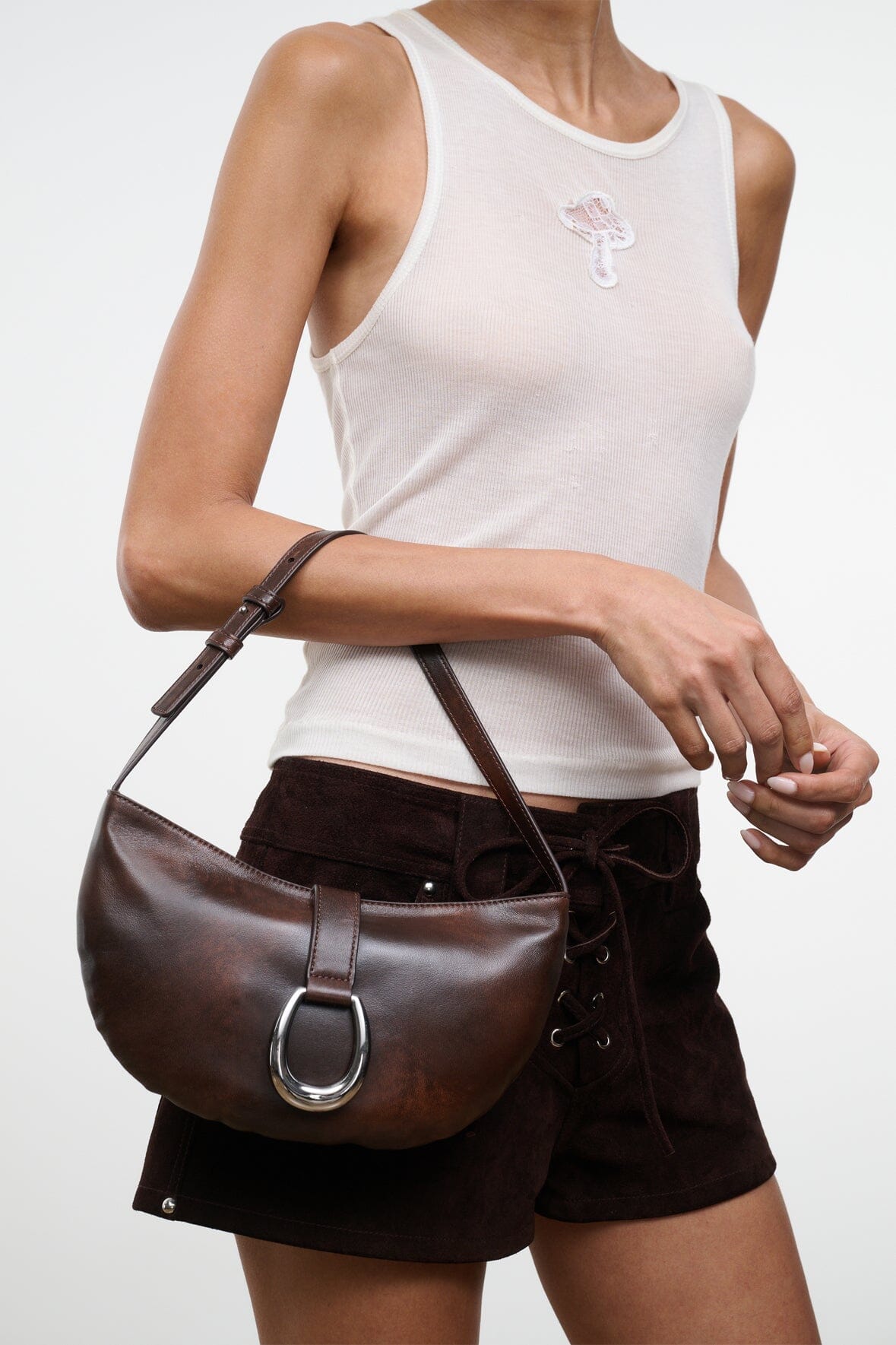 Espresso-brown crescent shoulder bag with silver O-ring clasp and adjustable shoulder strap