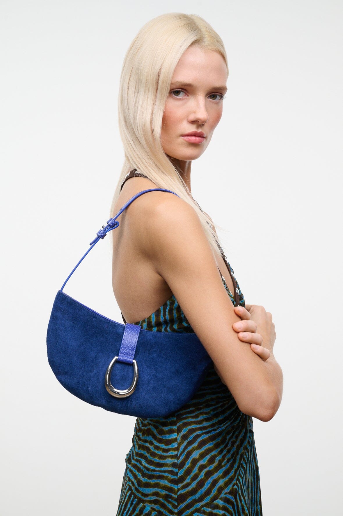 Cobalt crescent suede shoulder bag with side strap and silver ring clasp