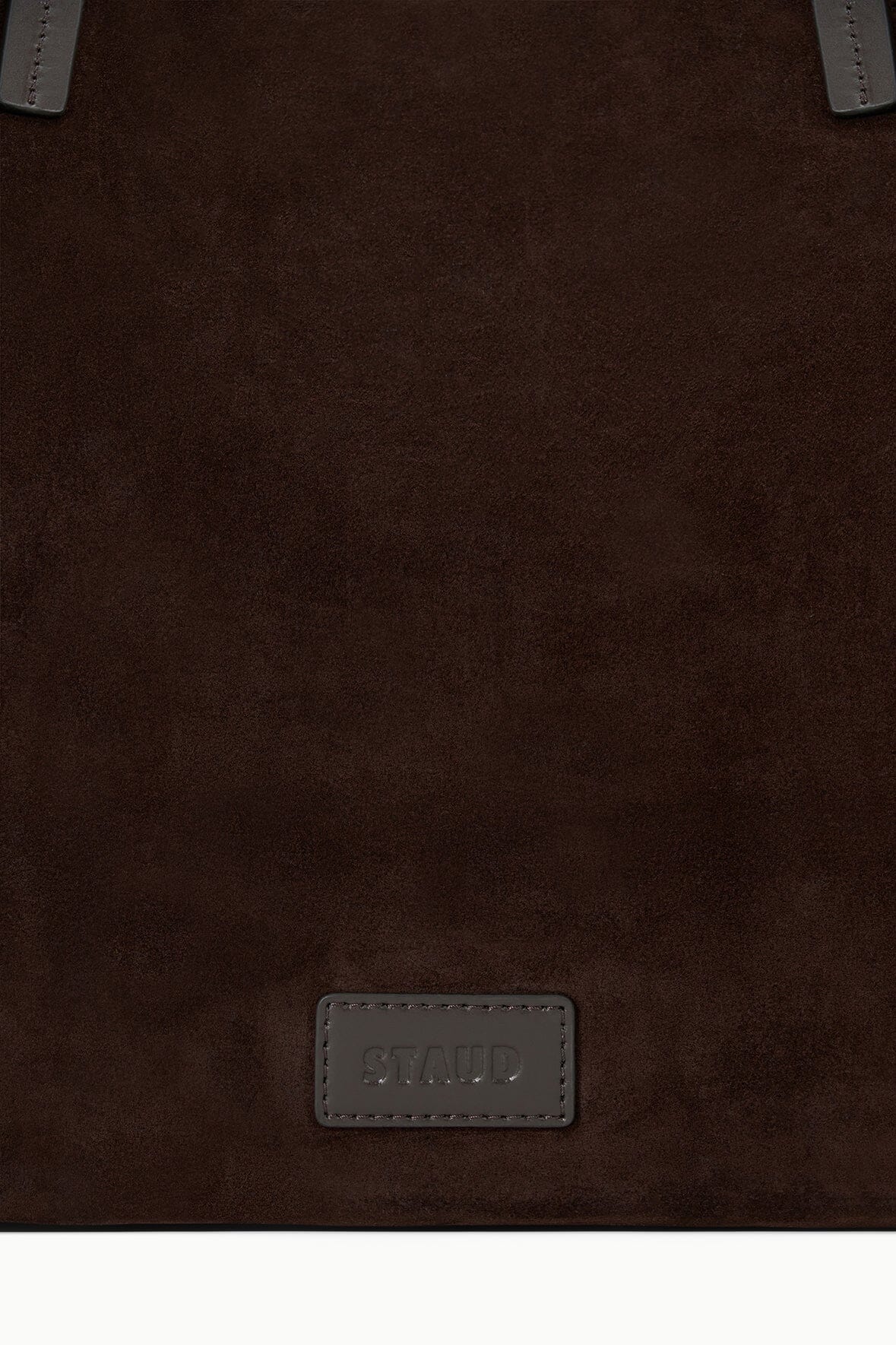 Brown suede tote front with stitched leather logo patch