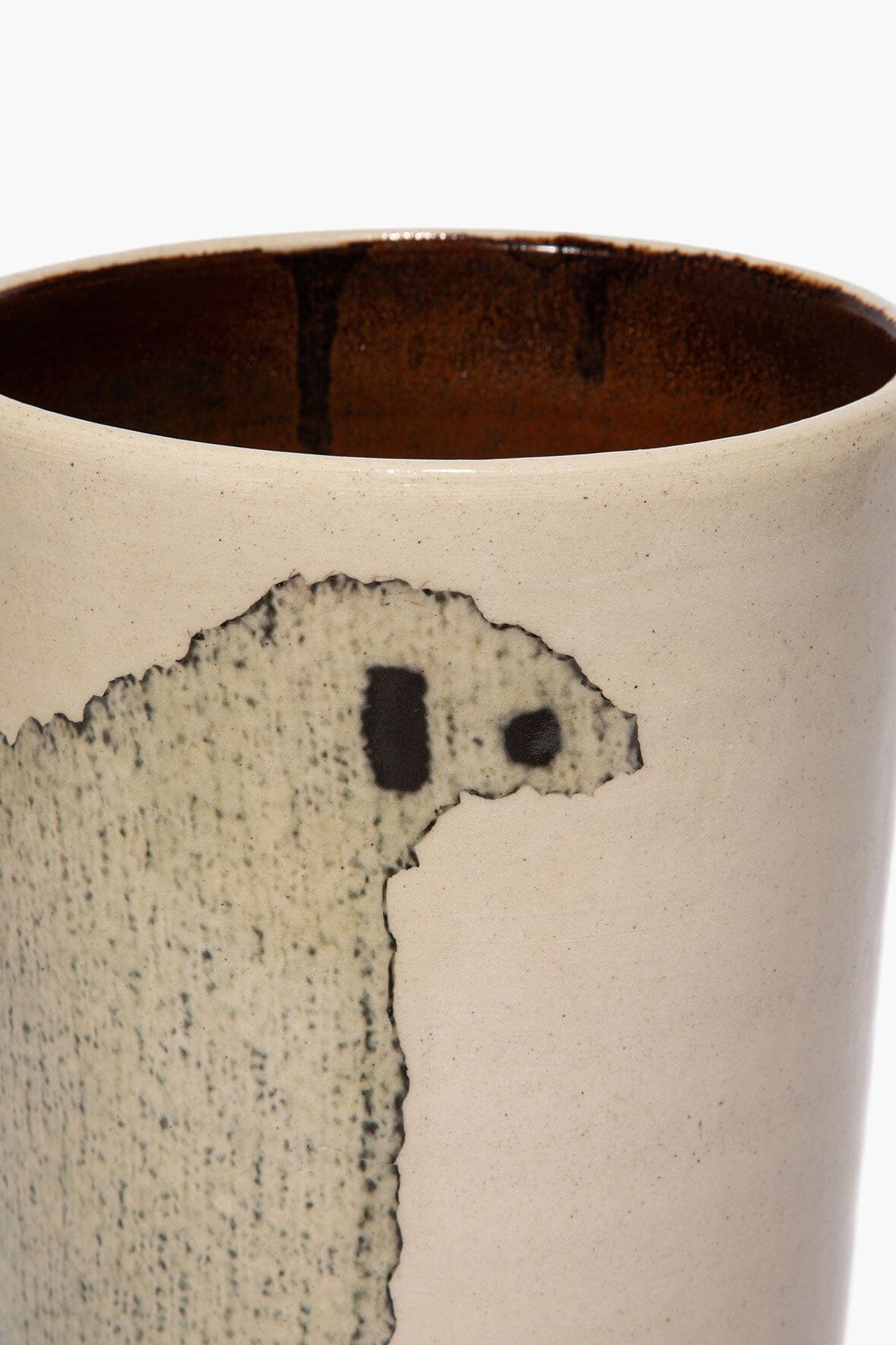 Tall ceramic sheep vase rim and sheep face detail on speckled beige