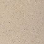Speckled beige ceramic surface close-up with small dark flecks