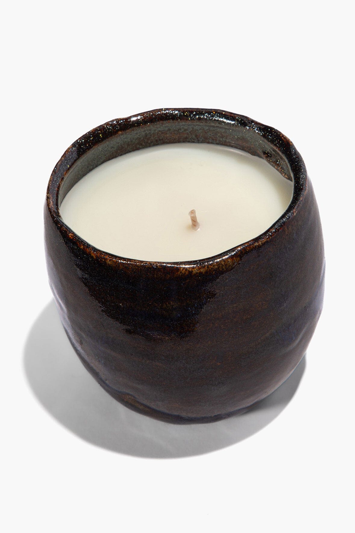Dark ceramic candle holder with cream wax and small wick