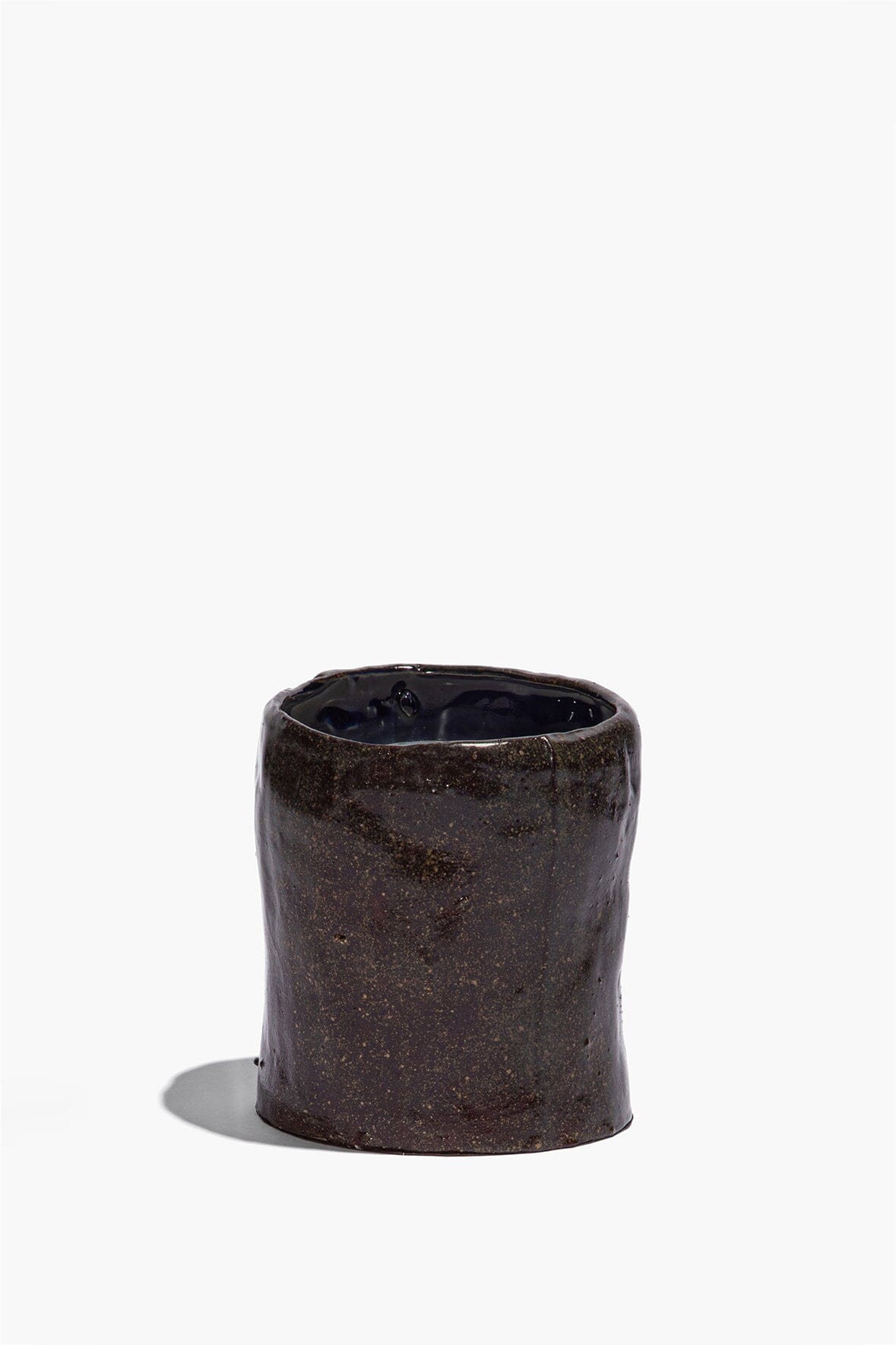 Small dark ceramic candle cup with speckled finish and dark inner rim