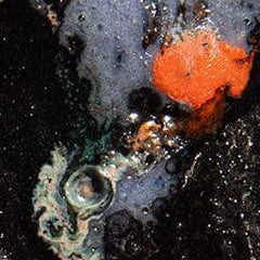 Ceramic incense holder glaze detail with blue, orange, and cream speckles