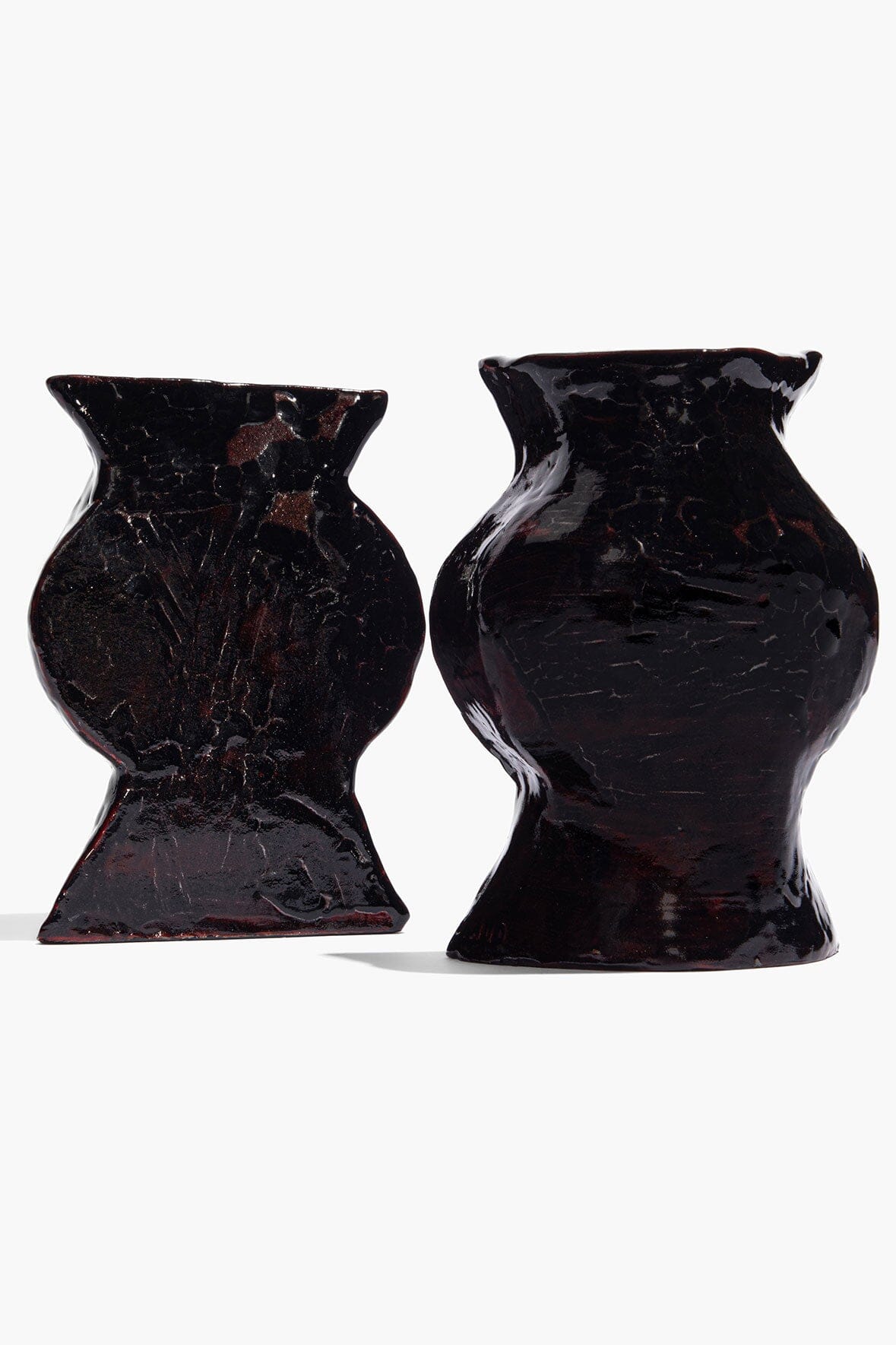 Black glossy ceramic vase bookends, front view of two angled vases