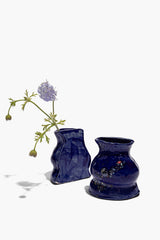 Two blue ceramic vase bookends with speckled polka-dot pattern