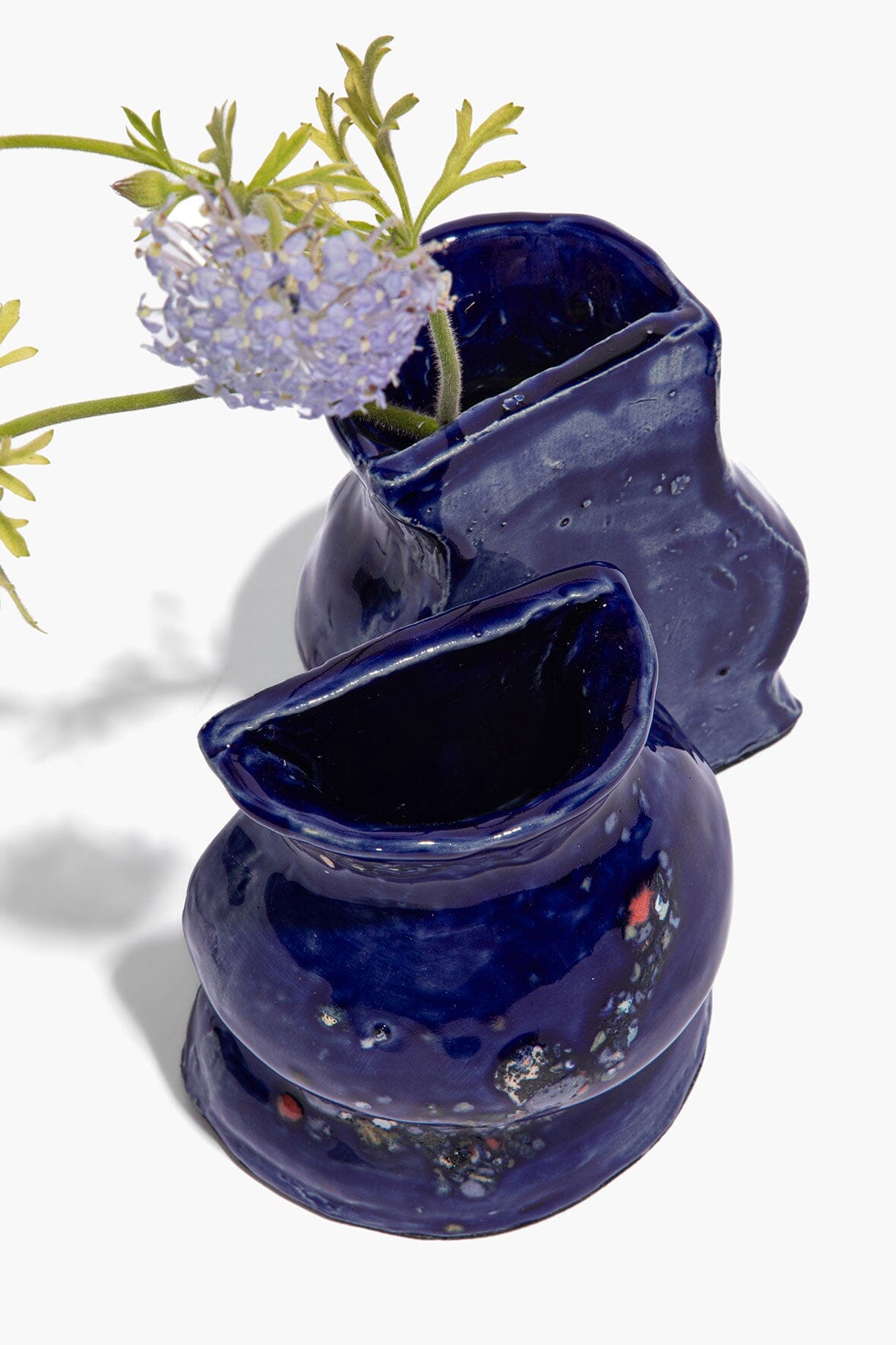 Blue ceramic vase bookends with speckled polka-dot style detailing